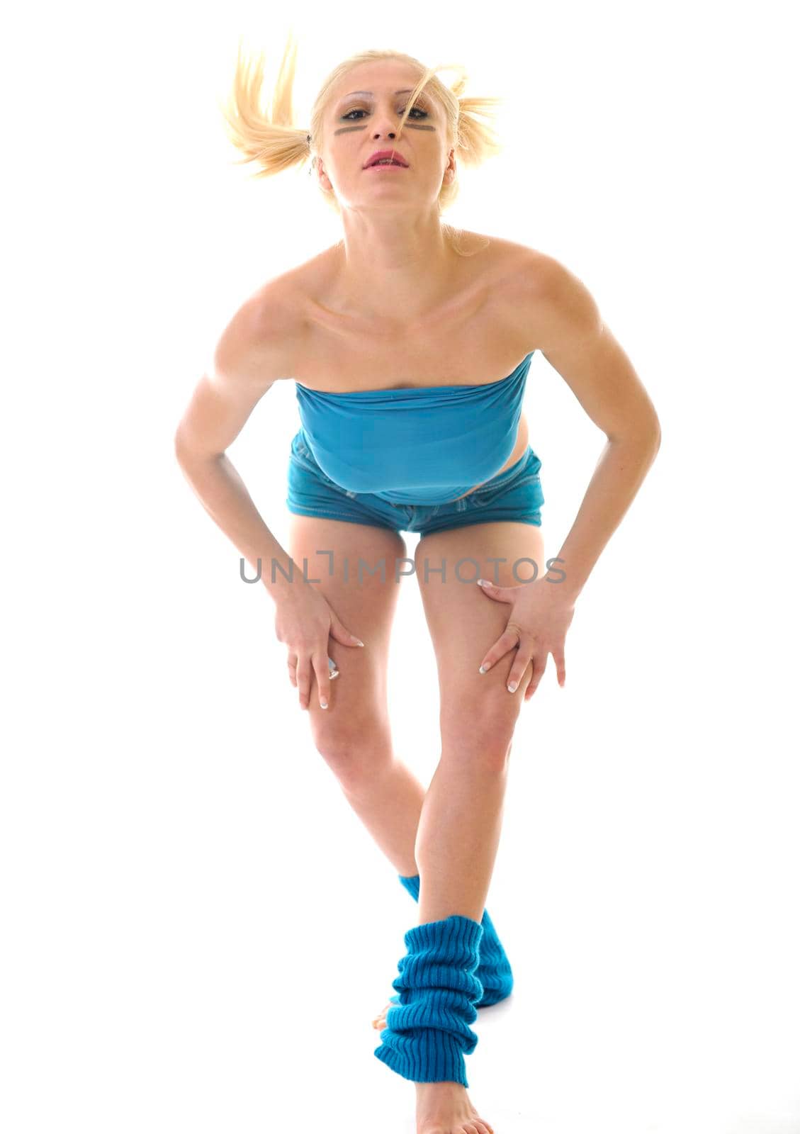 young woman exercise fitness isolated on white on blue clothing and with red pilates ball