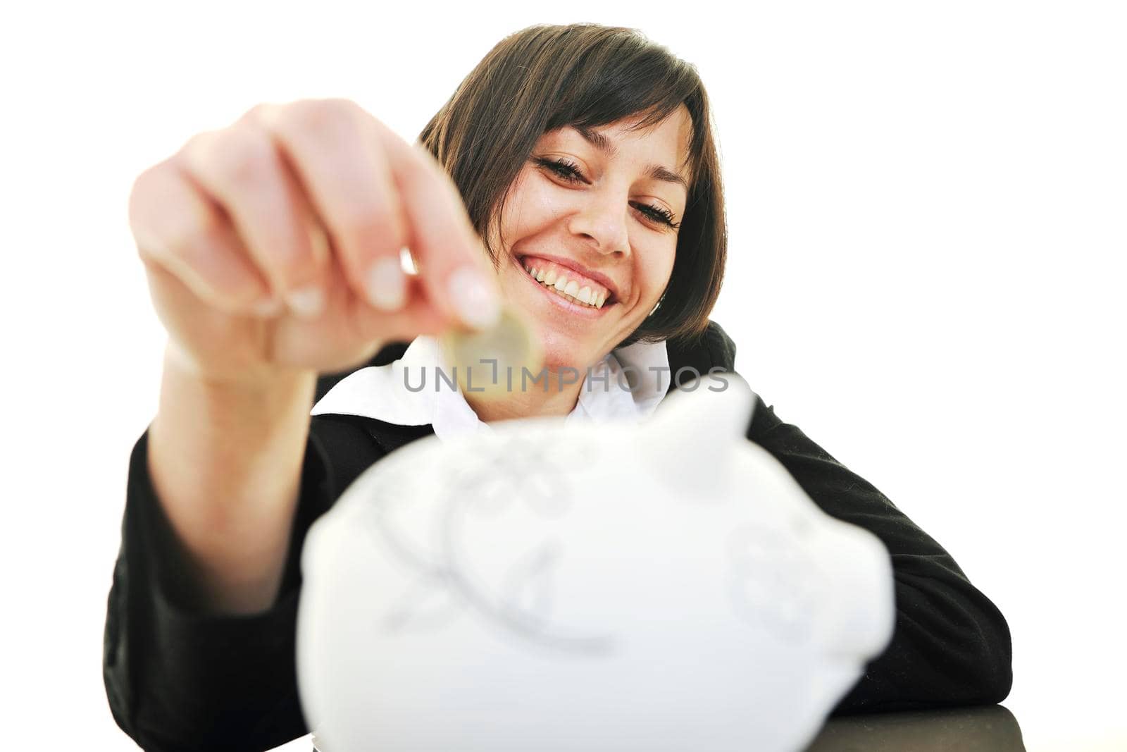 happy young business woman isolated on white puting euro money in piggy bank