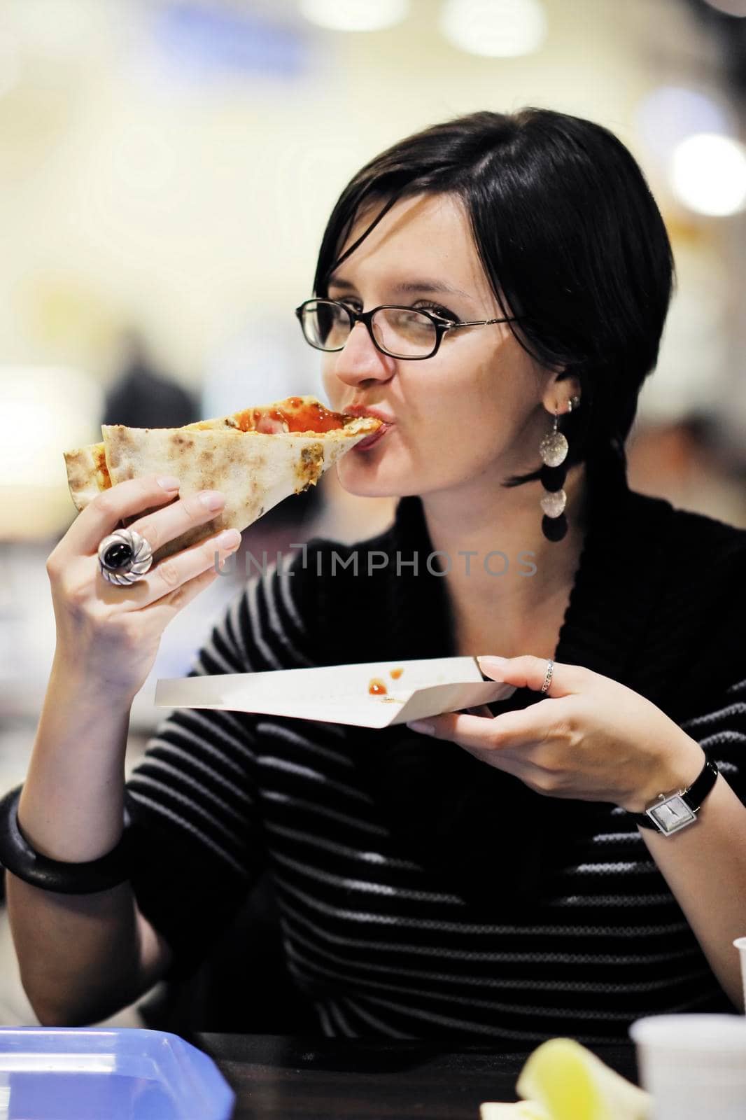 woman eat pizza food at restaurant by dotshock