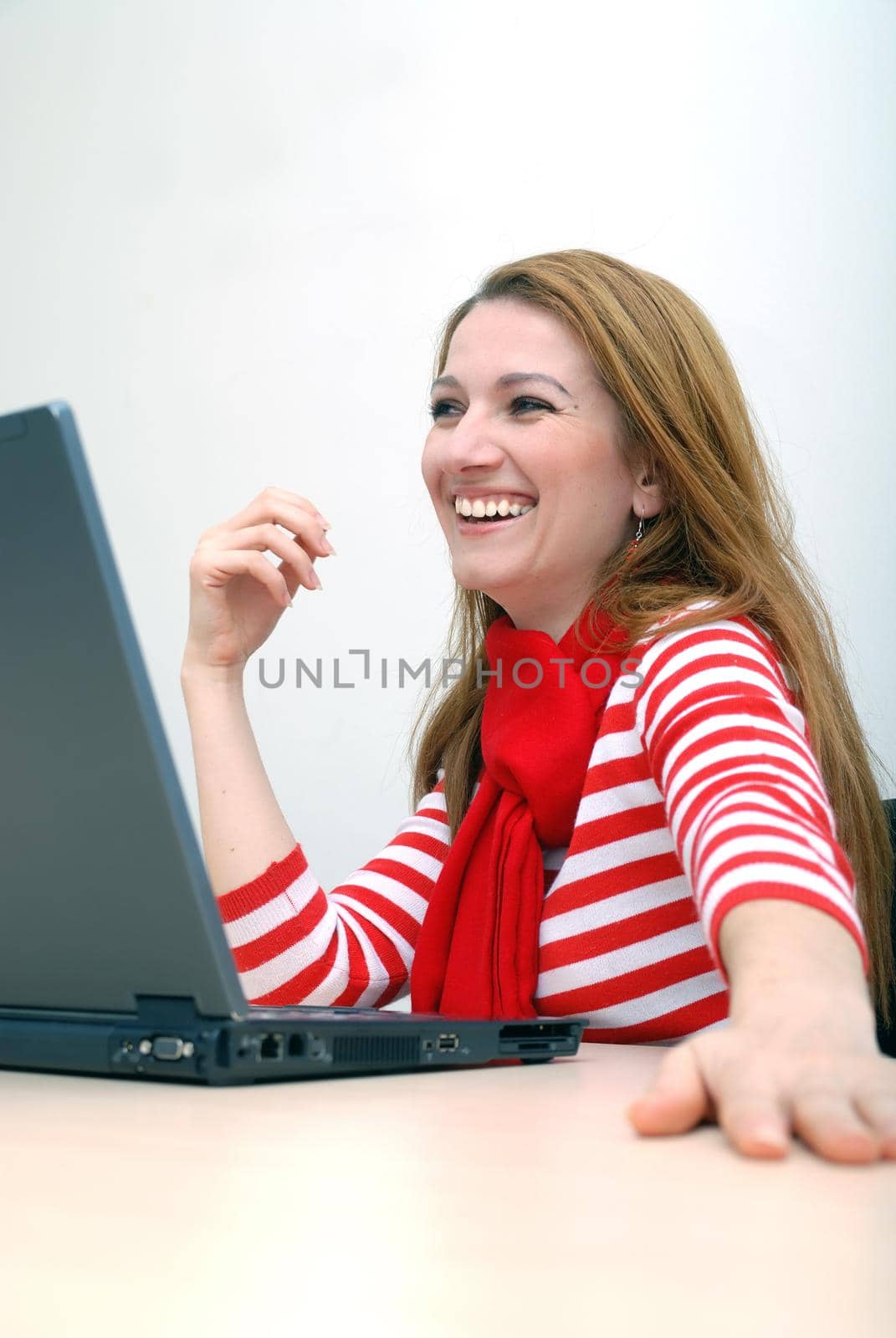 woman in red working on laptop at bright  office