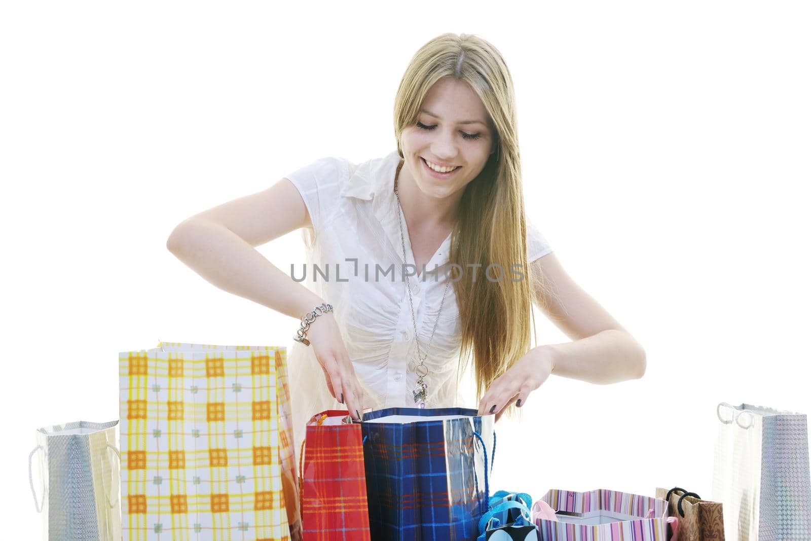 women shopping concept with young lady and colored bags  isolated over white background in studio