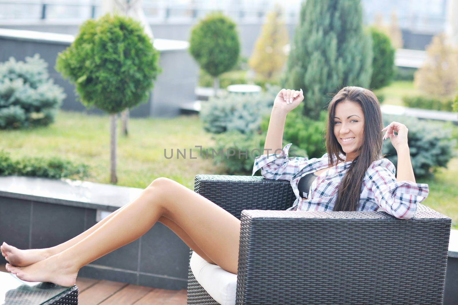 beautiful young woman lady posing in green moden outdoor garden