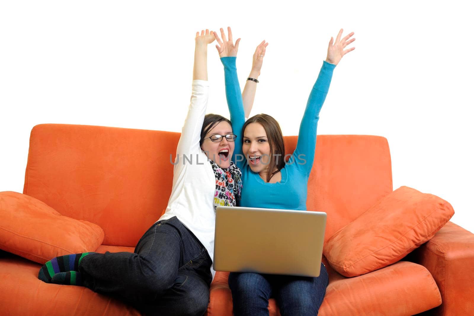 female friends relax and working on  laptop computer at home on orange sofa isolated on white backgrond