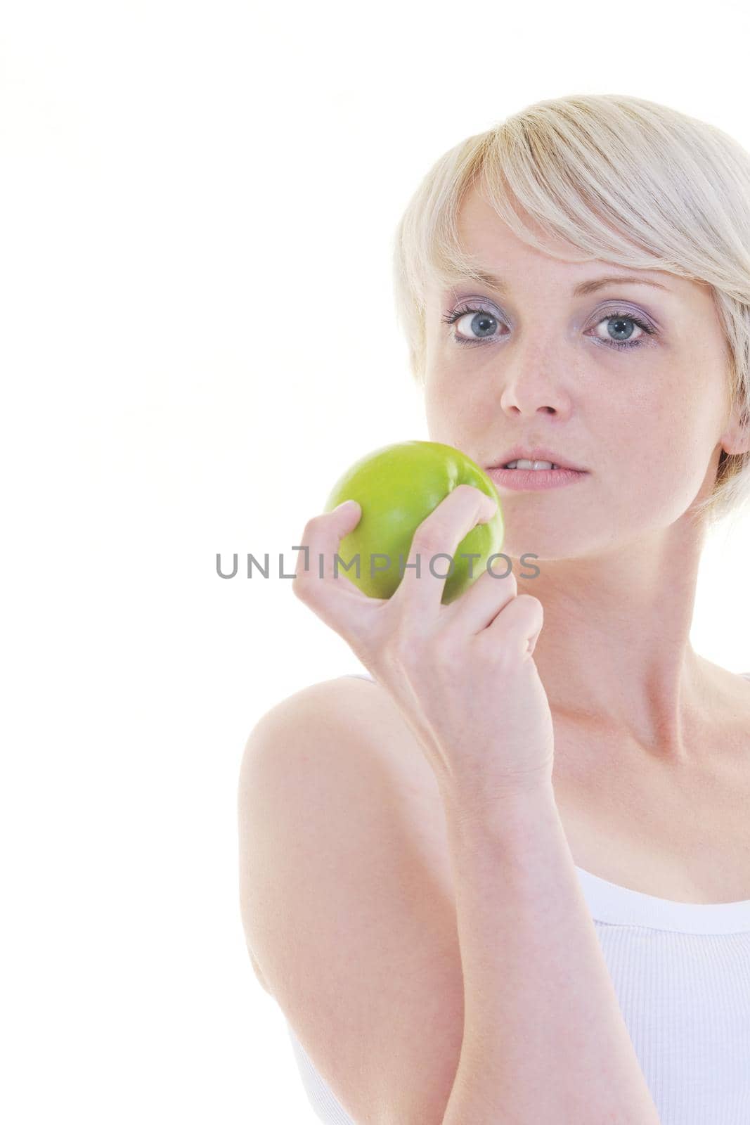 happy young woman eat green apple isolated  on white backround in studio