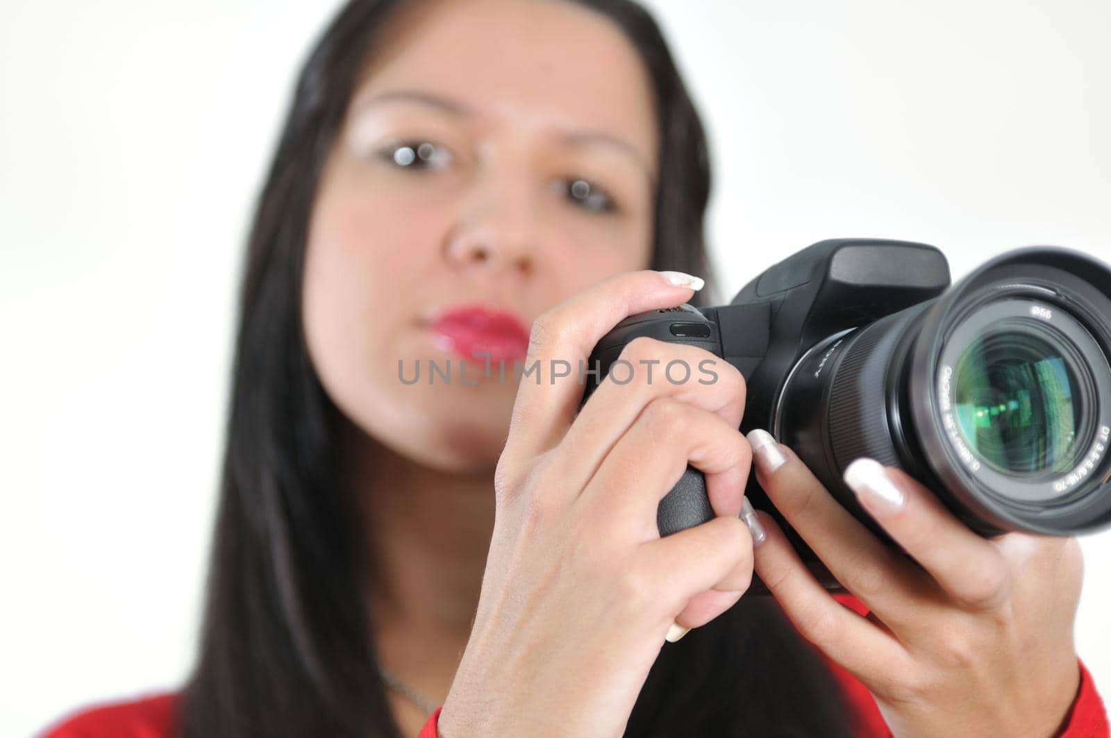 Young woman holding camera in hand taking picture isolated