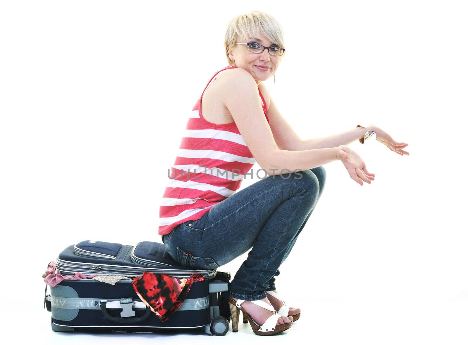 woman tourist packing travel bag isolated on white backgound in studio