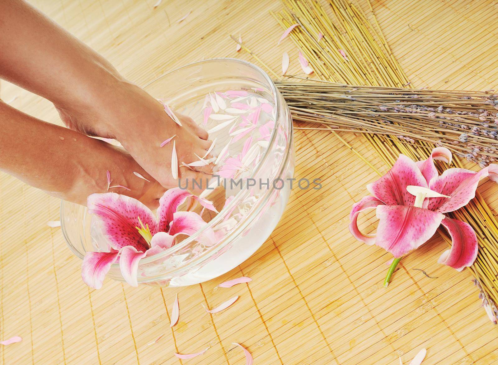 woman spa pedicure foot treatment with water and flower