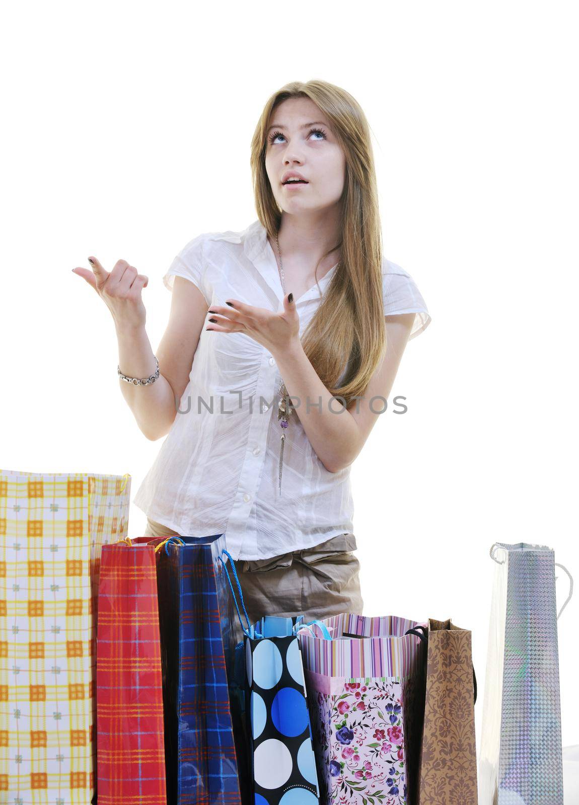 women shopping concept with young lady and colored bags  isolated over white background in studio