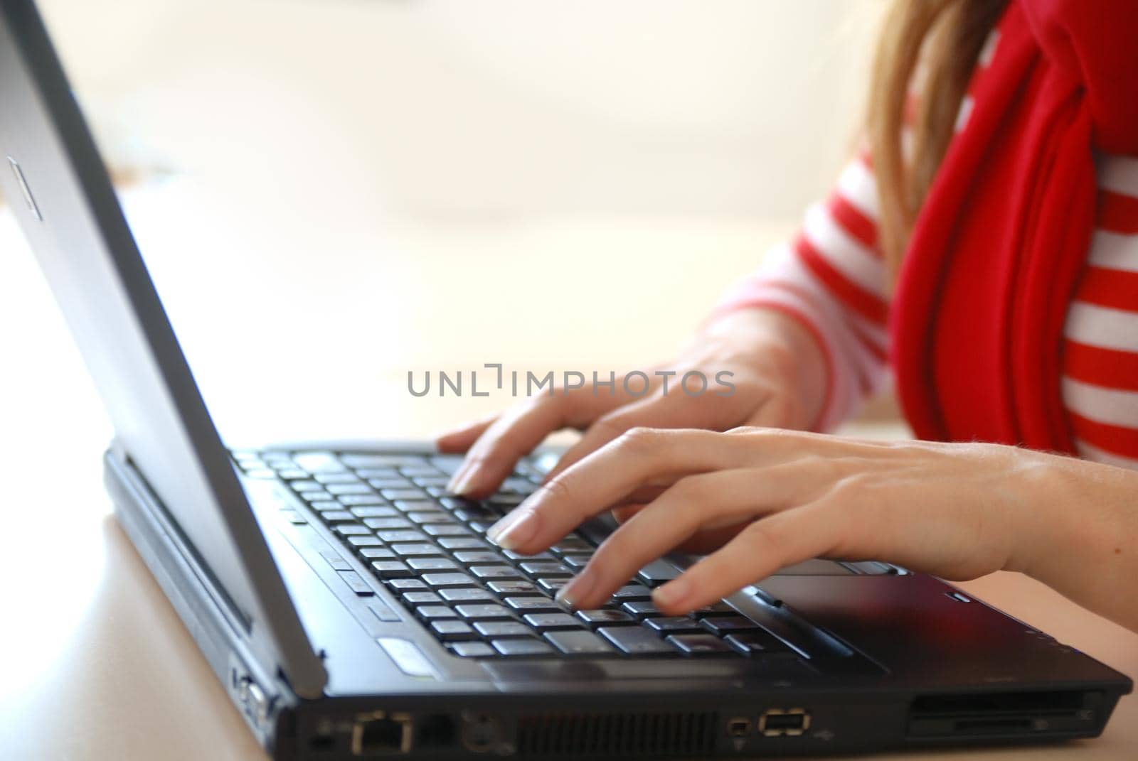 woman in red working on laptop at bright  office