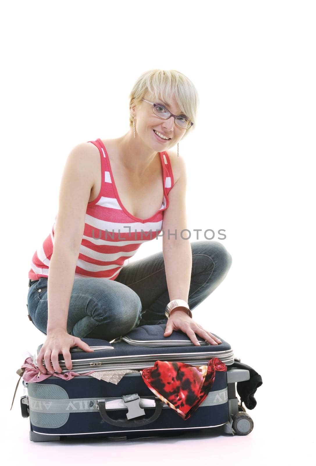 woman tourist packing travel bag isolated on white backgound in studio