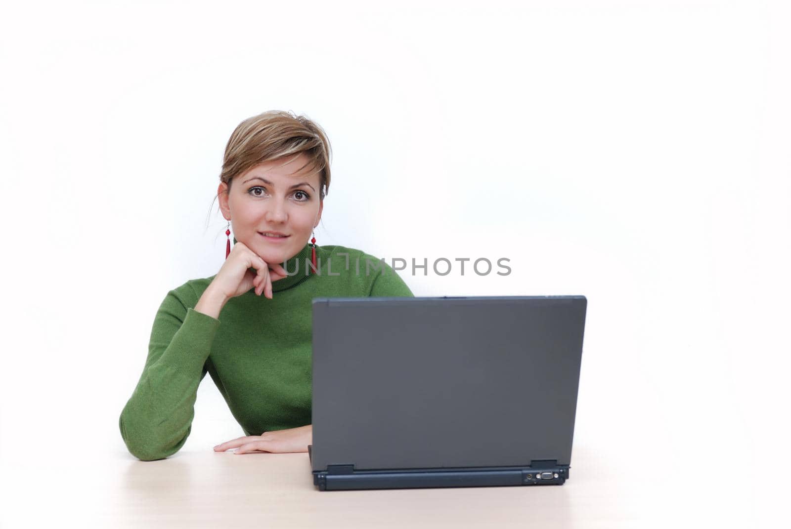 businesswoman in green working on laptop