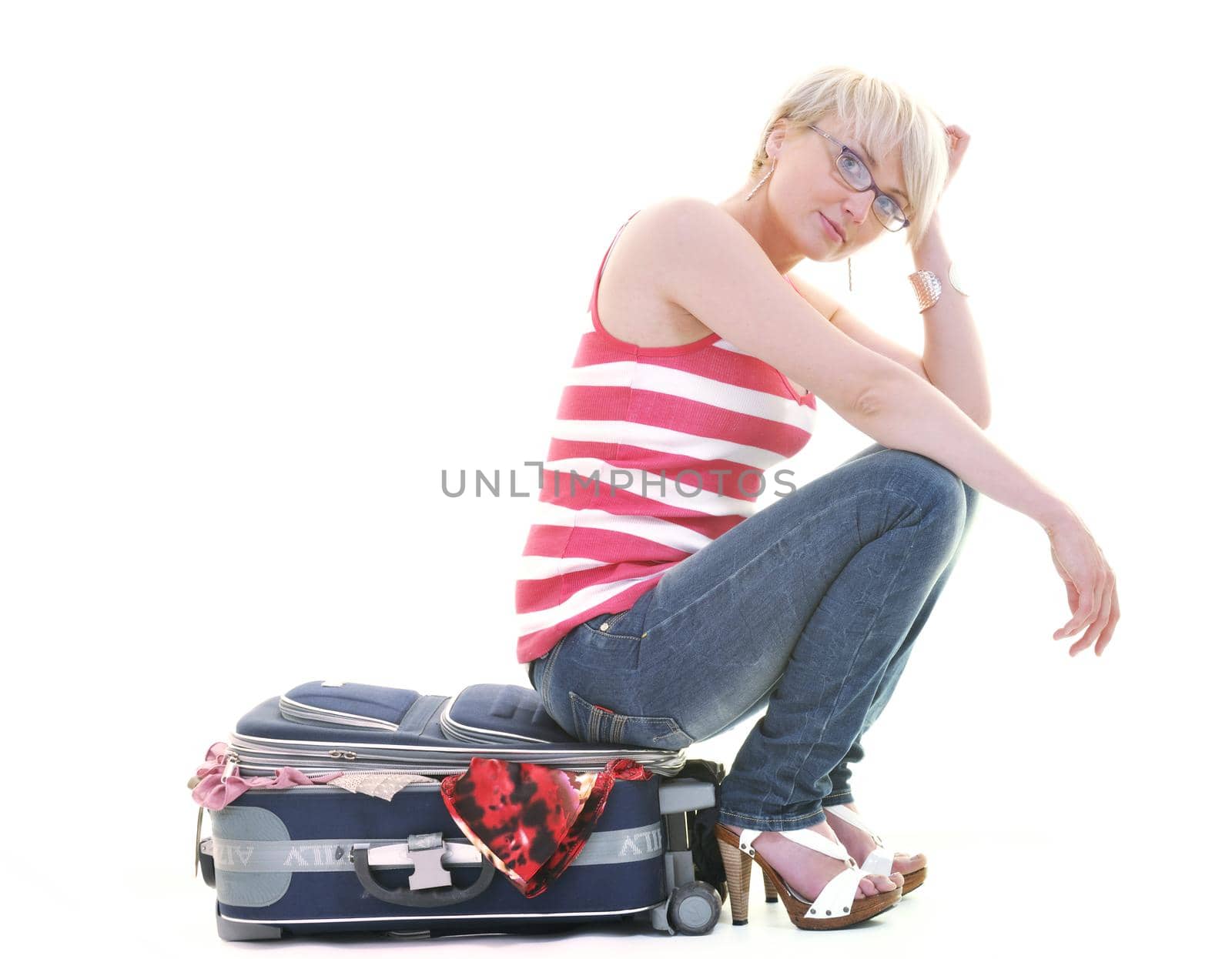 woman tourist packing travel bag isolated on white backgound in studio