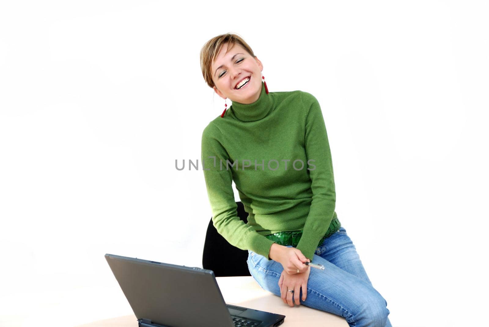 businesswoman in green working on laptop