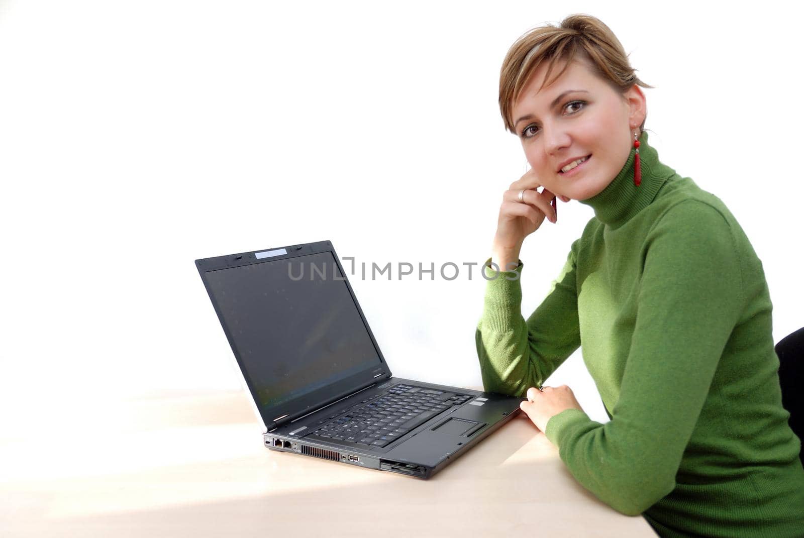 businesswoman in green working on laptop