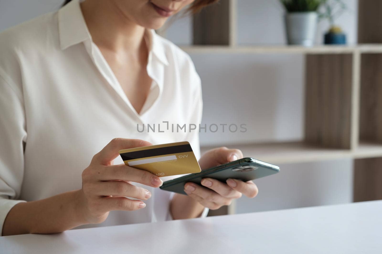 Woman enjoy with online shopping application and typing credit card for fill number to payment. by itchaznong