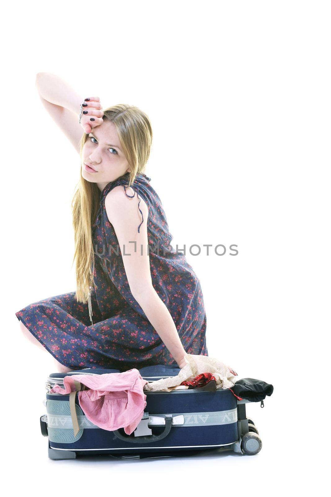 woman tourist packing travel bag isolated on white backgound in studio