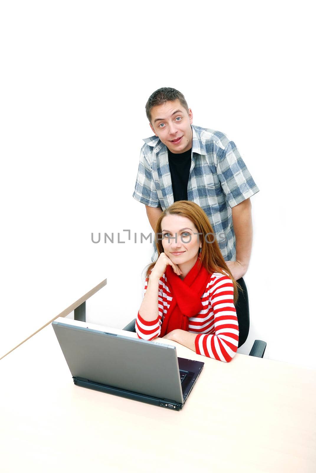 young couple working on laptop at office