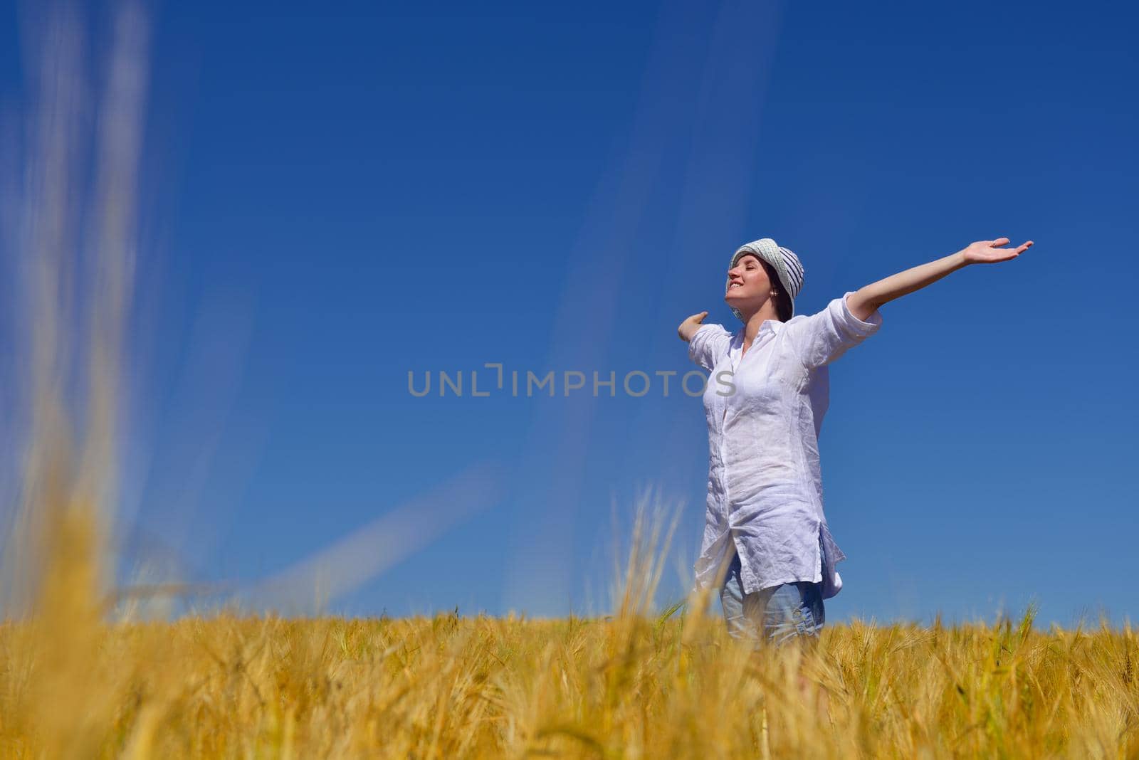 healthy Happy  young woman with spreading arms, blue sky with clouds in background  - copyspace