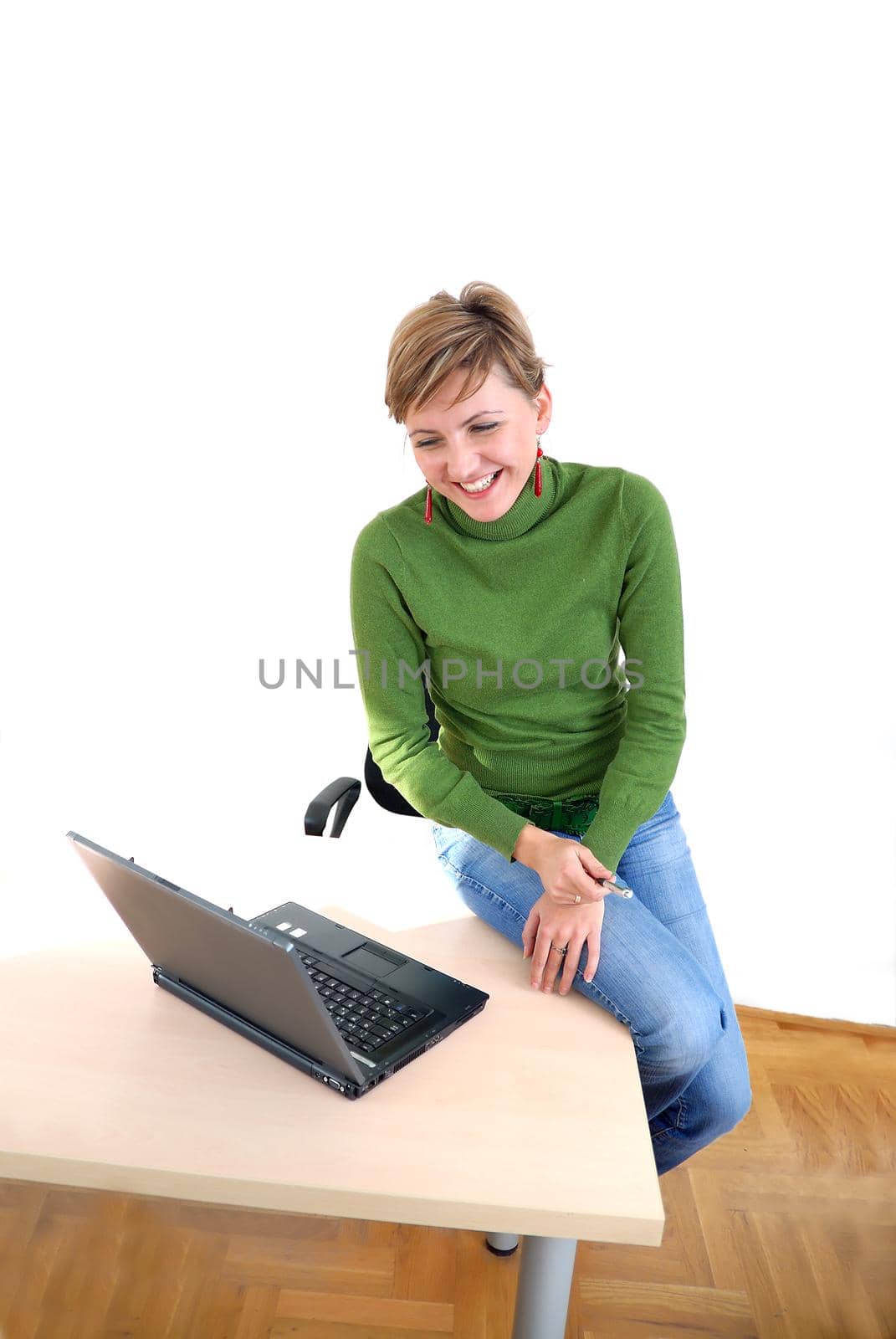 businesswoman in green working on laptop