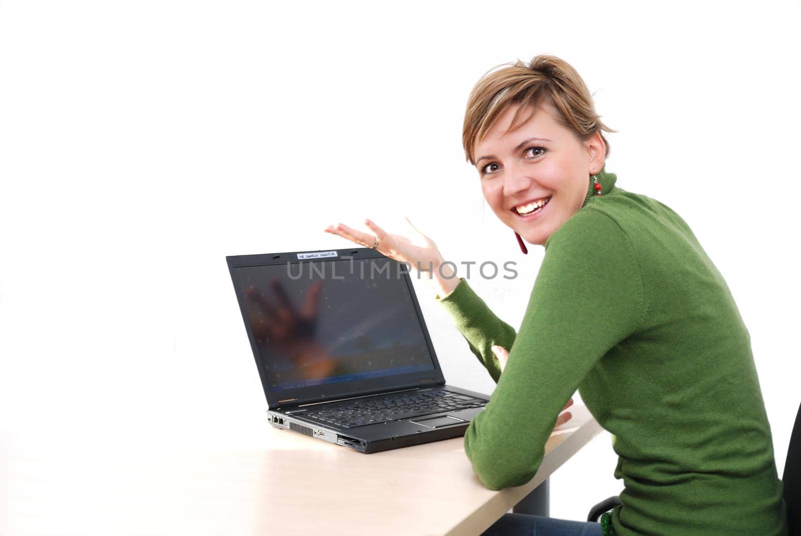 businesswoman in green working on laptop