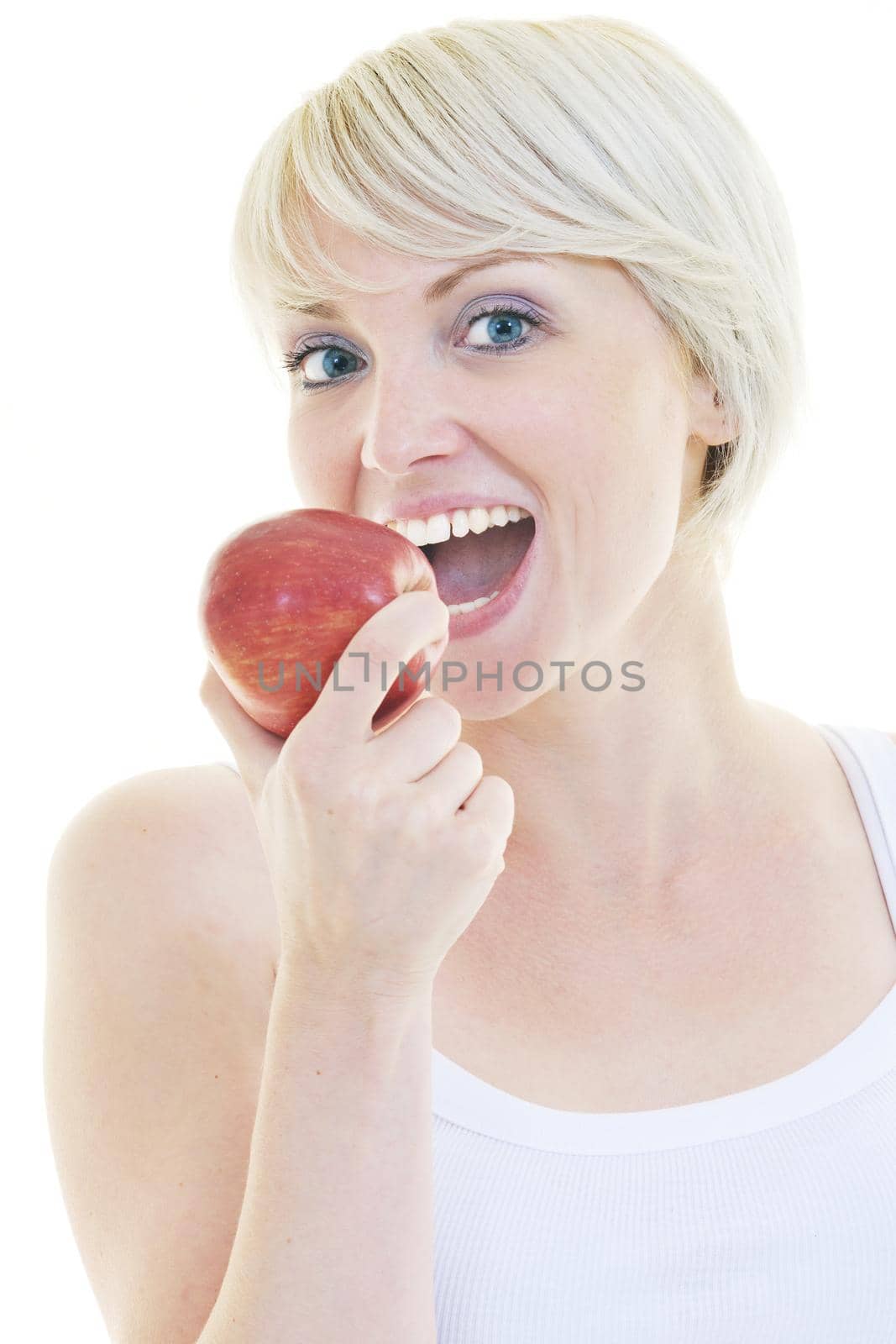 happy young woman eat green apple isolated  on white backround in studio