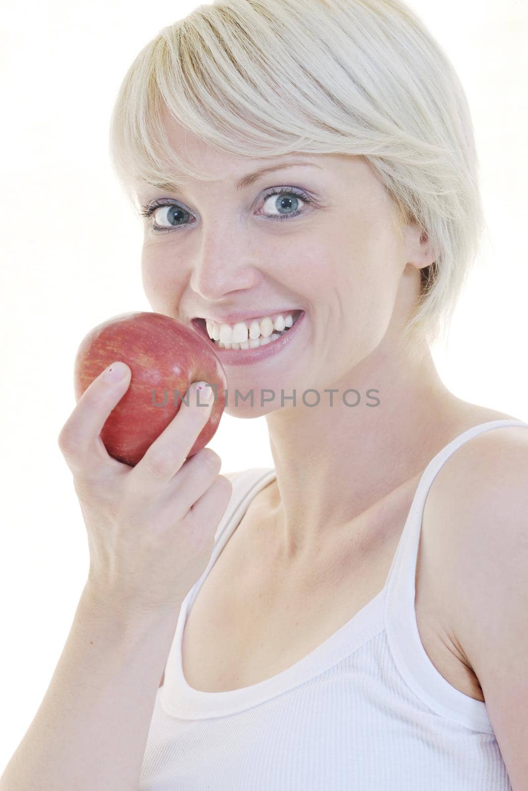 happy young woman eat green apple isolated  on white backround in studio