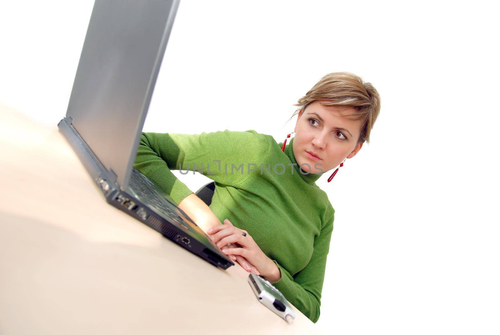 businesswoman in green working on laptop