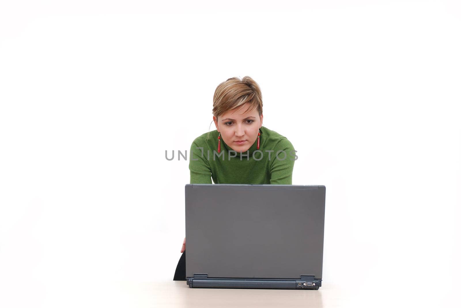 businesswoman in green working on laptop