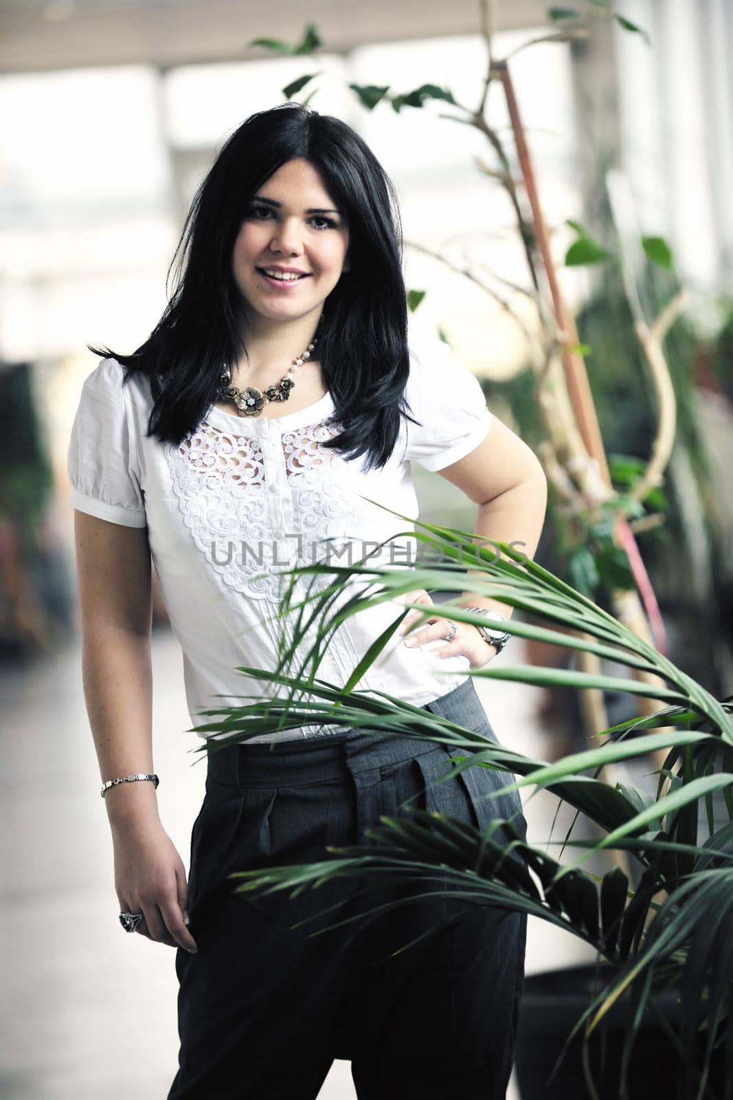 young happy business woman or student posing in fashionable clothes indoor in bright building 