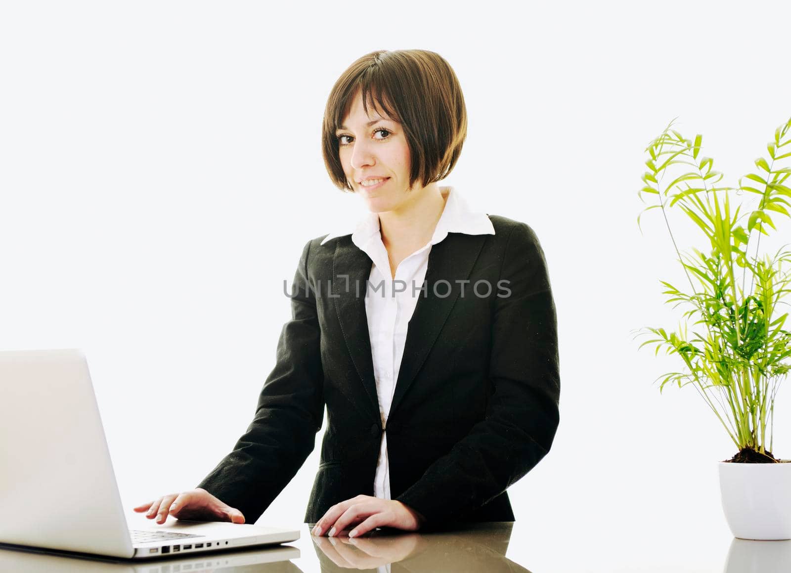 one young business woman isolated on white working on laptop computer