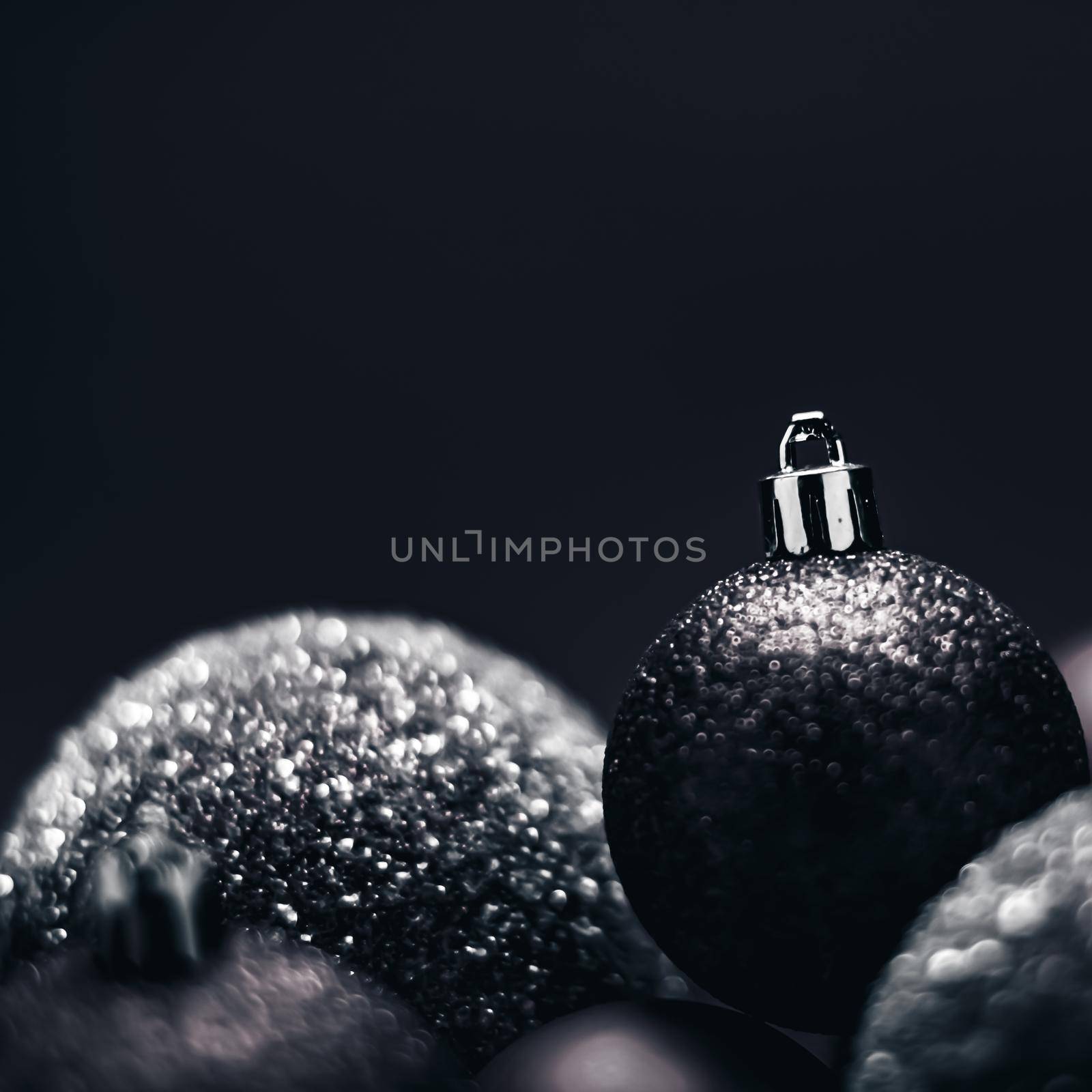 Christmas holiday and festive decoration concept. Black baubles as minimalistic xmas background by Anneleven