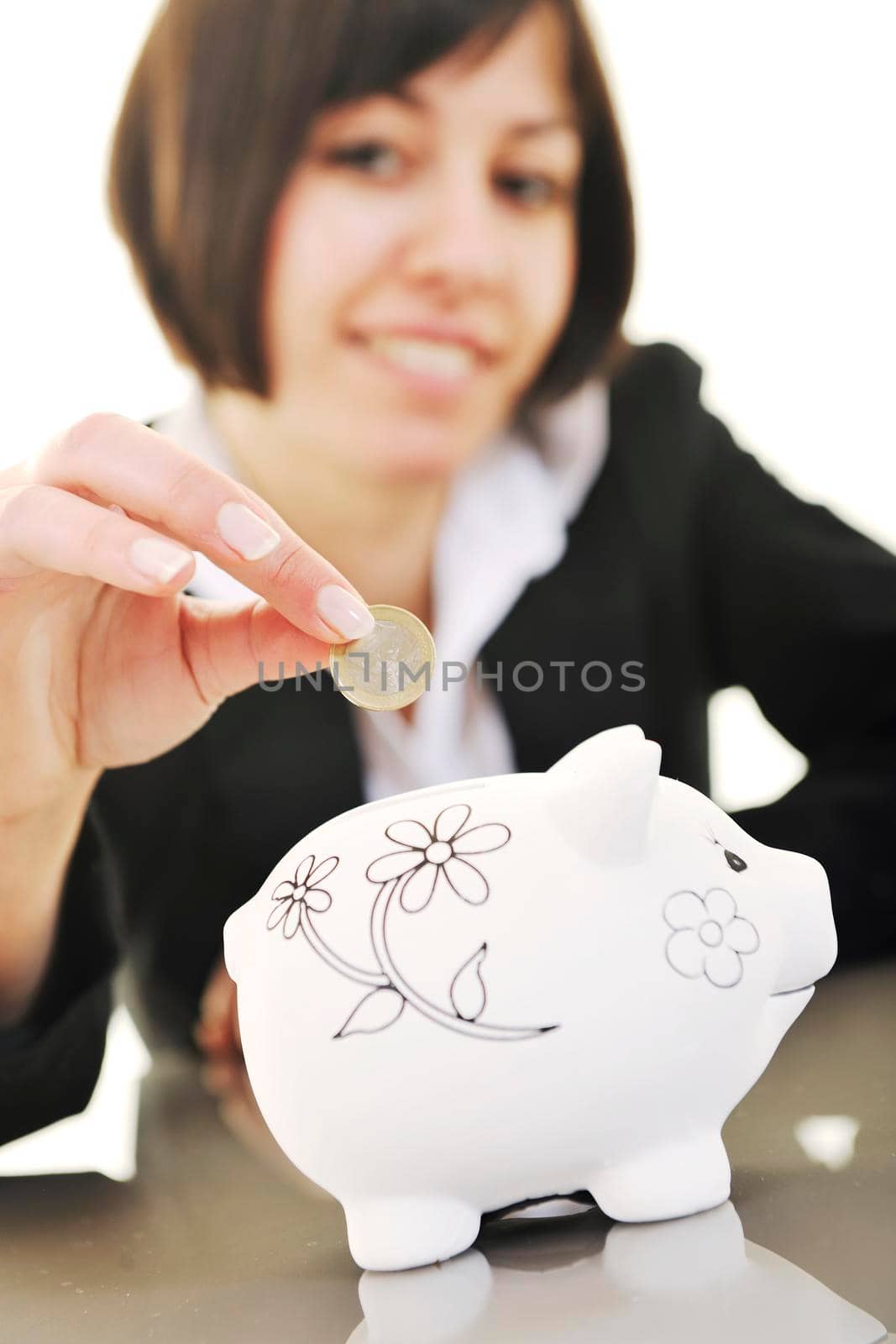 happy young business woman isolated on white puting euro money in piggy bank