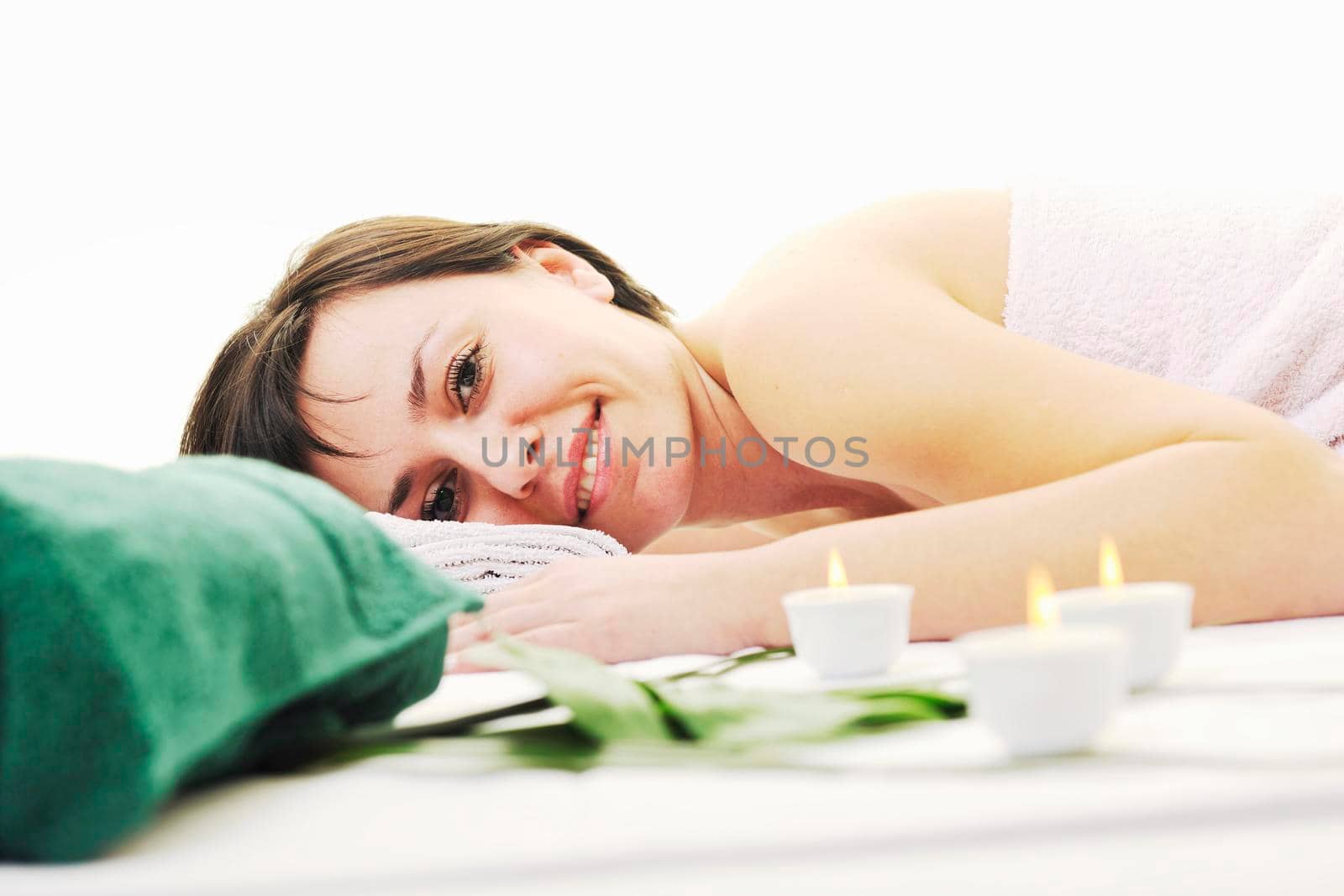 young woman relax and enjoy back massage treatment isolated on white