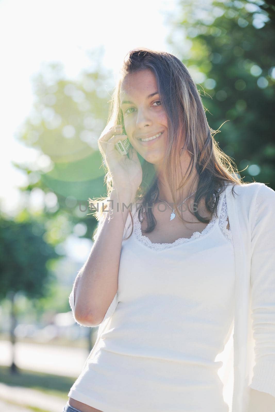 beautiful fit young woman talk by cellphone in city at street on sunny day