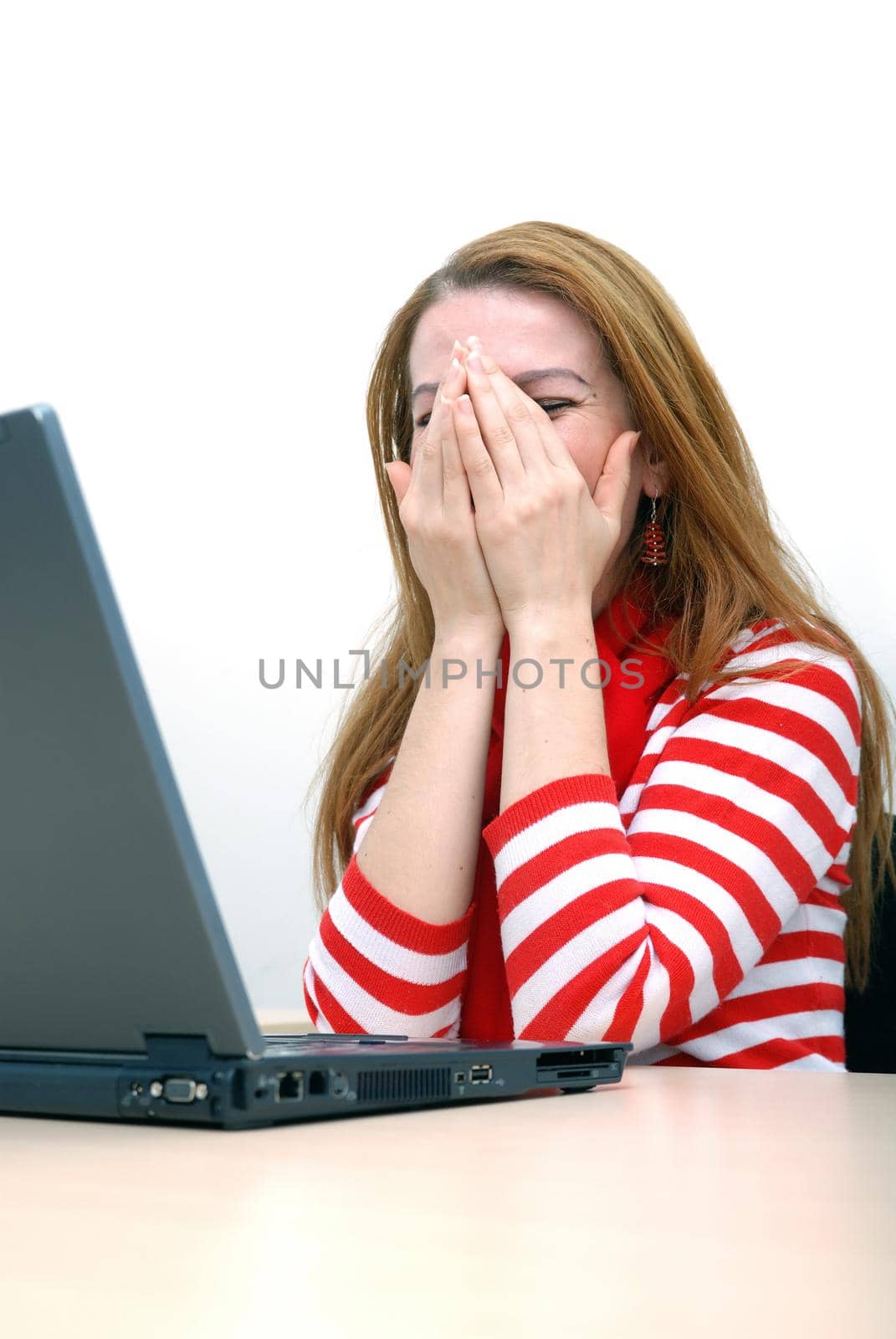 woman in red working on laptop at bright  office