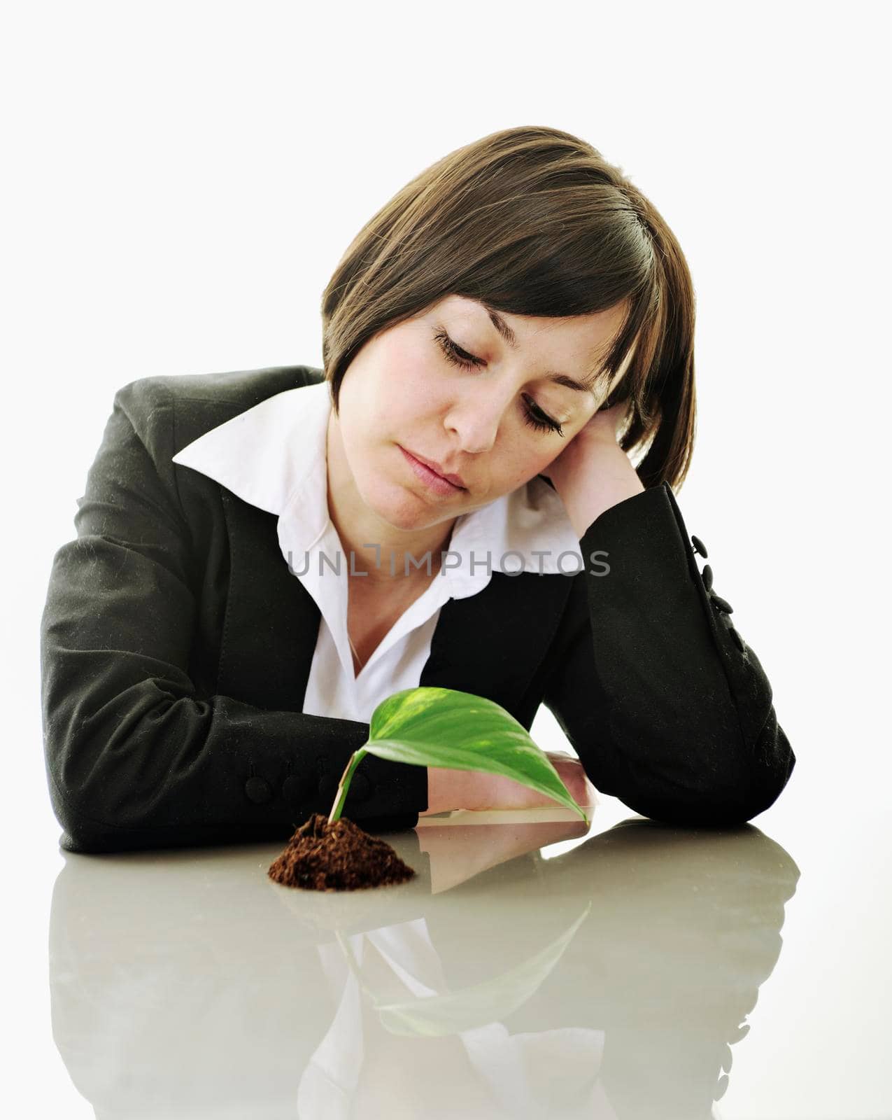 young business woman isolated on white holding green plant with small leaf and waiting to grow