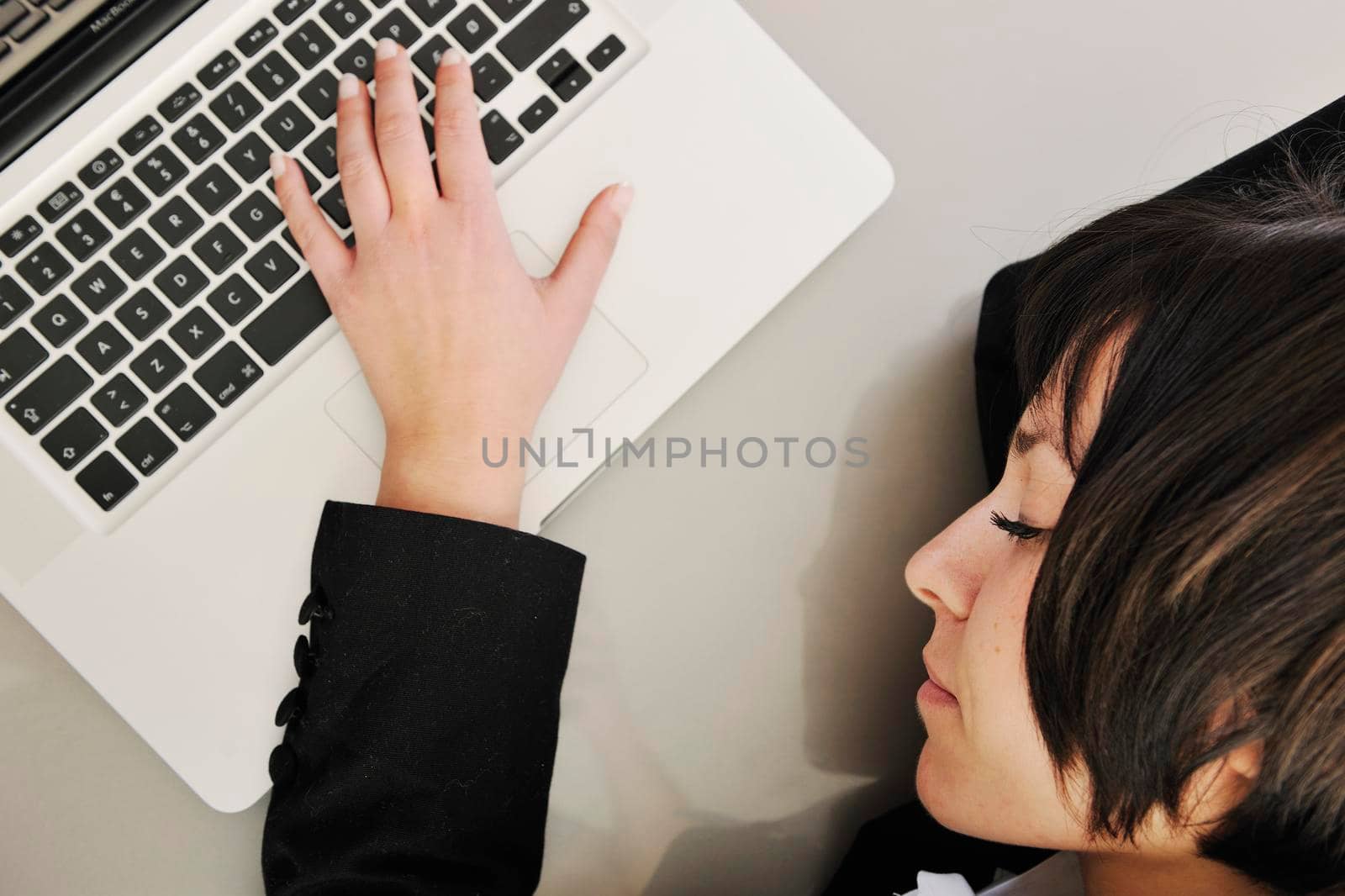 one young business woman isolated on white working on laptop computer