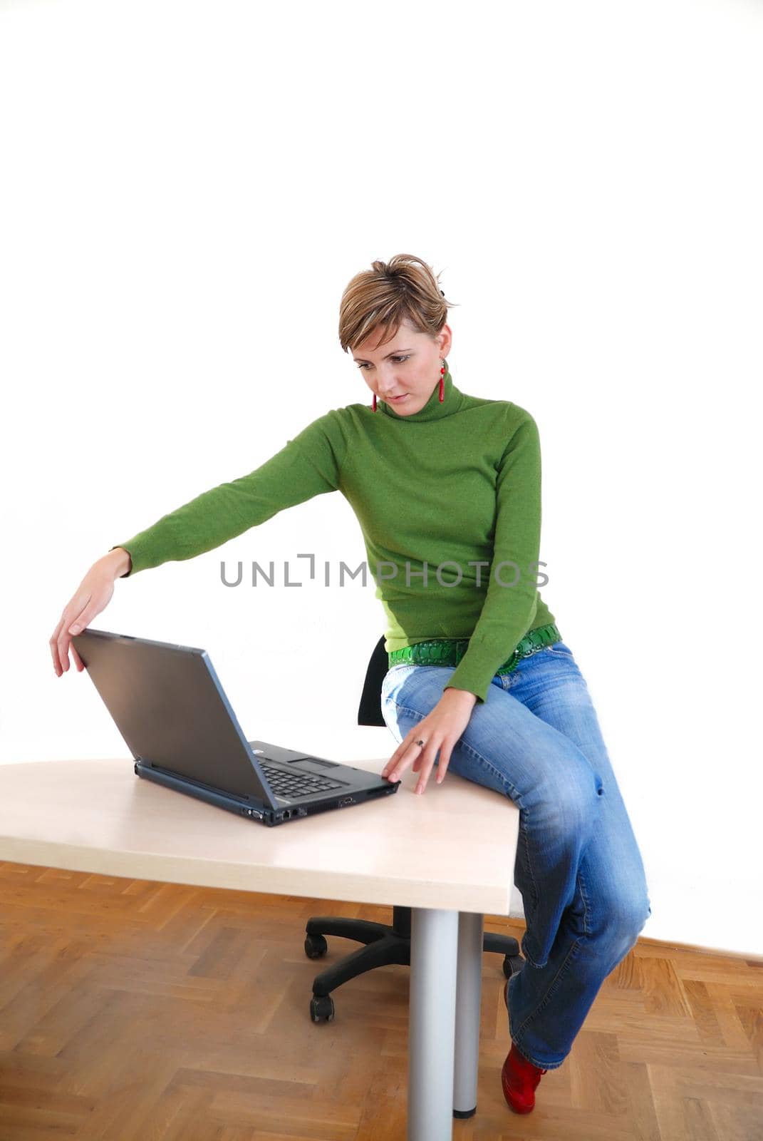 businesswoman in green working on laptop