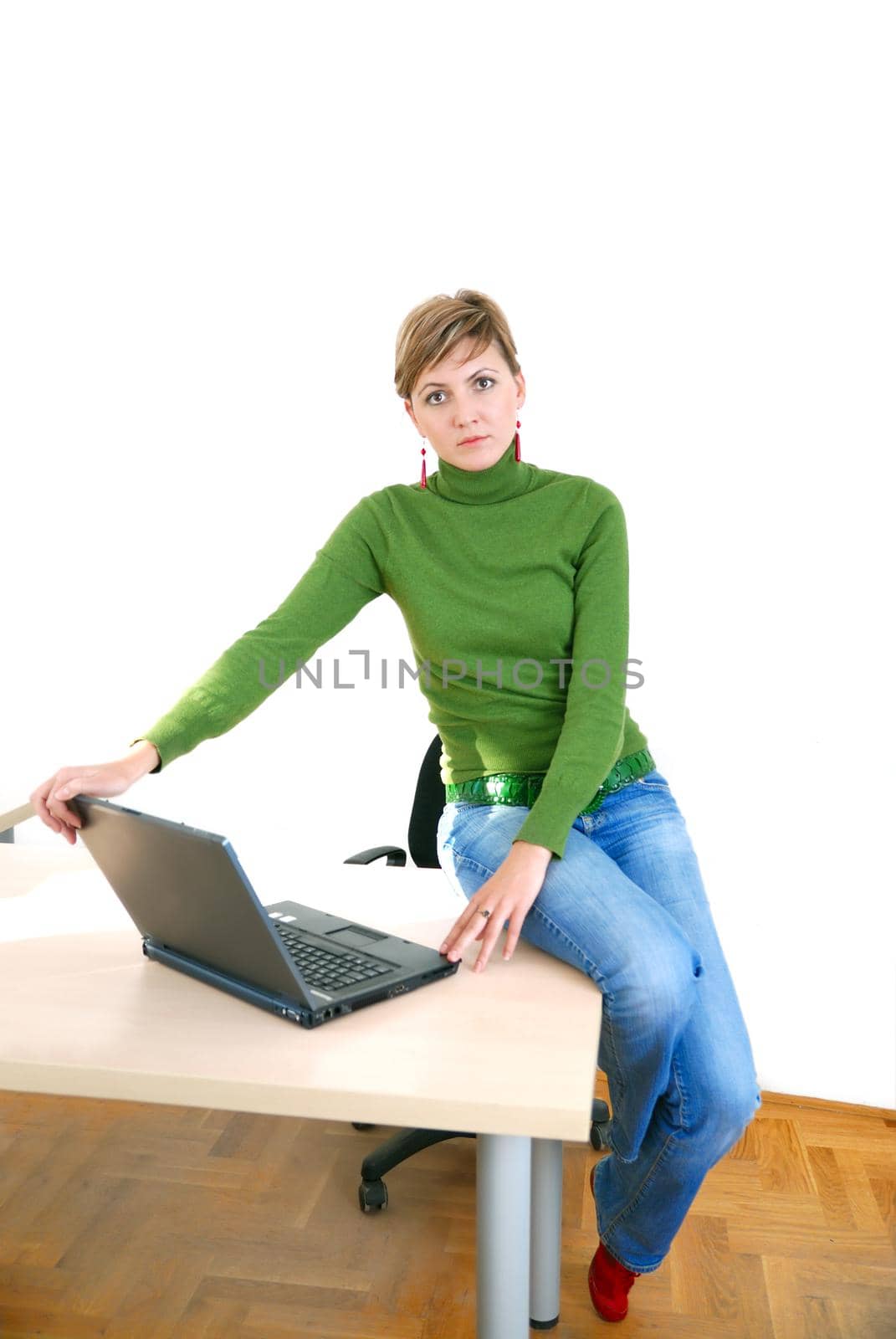 businesswoman in green working on laptop