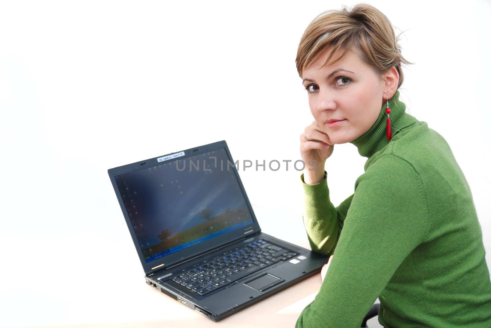 businesswoman in green working on laptop