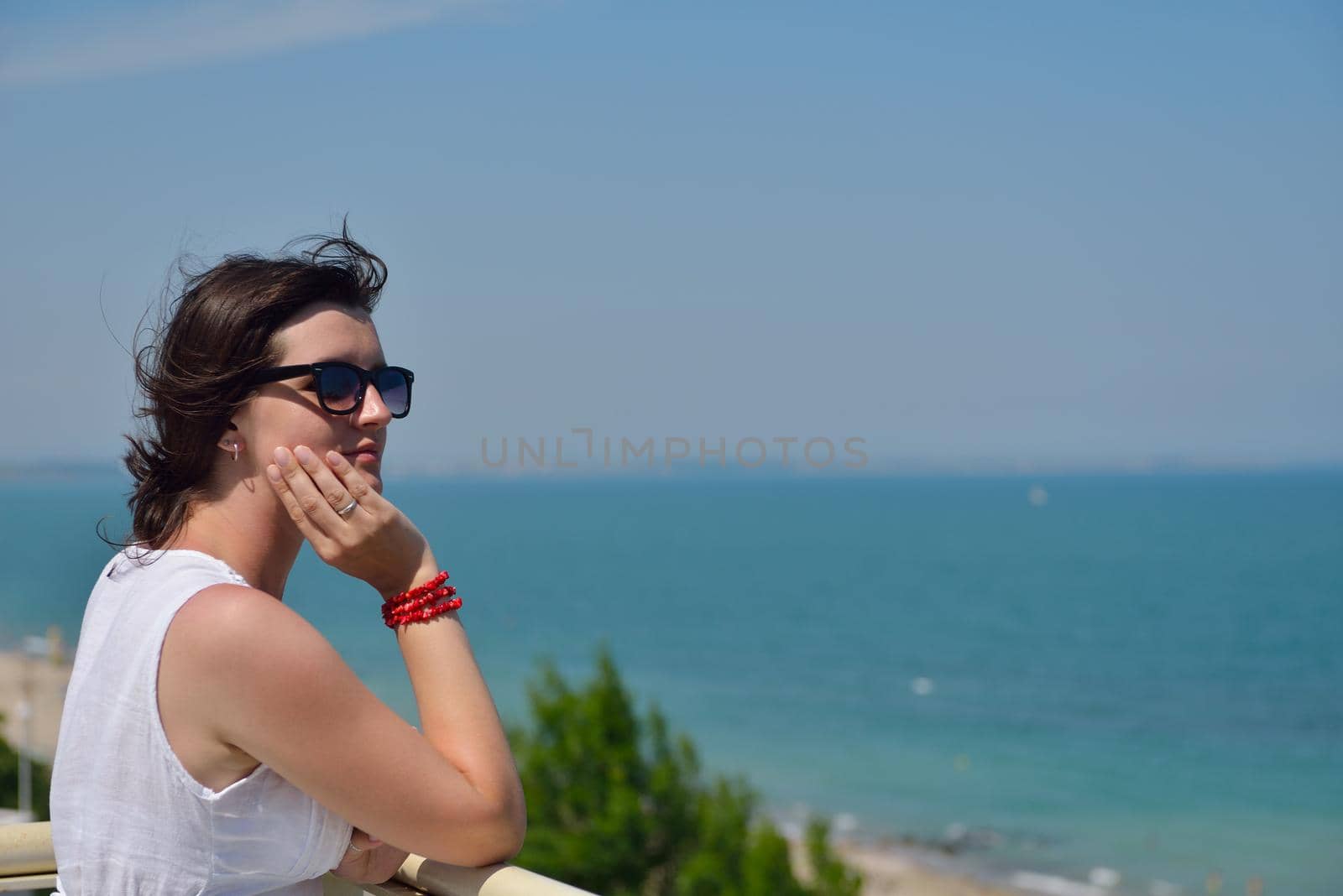 happy young tourist woman have fun while traveling araund city with blue sky and sea in background