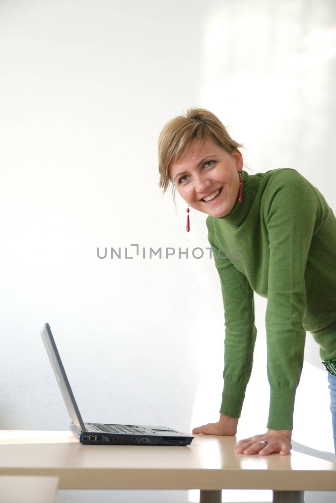 business woman in green standing in office