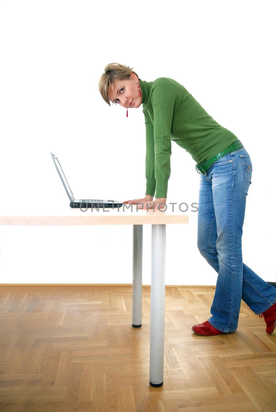 business woman in green standing in office