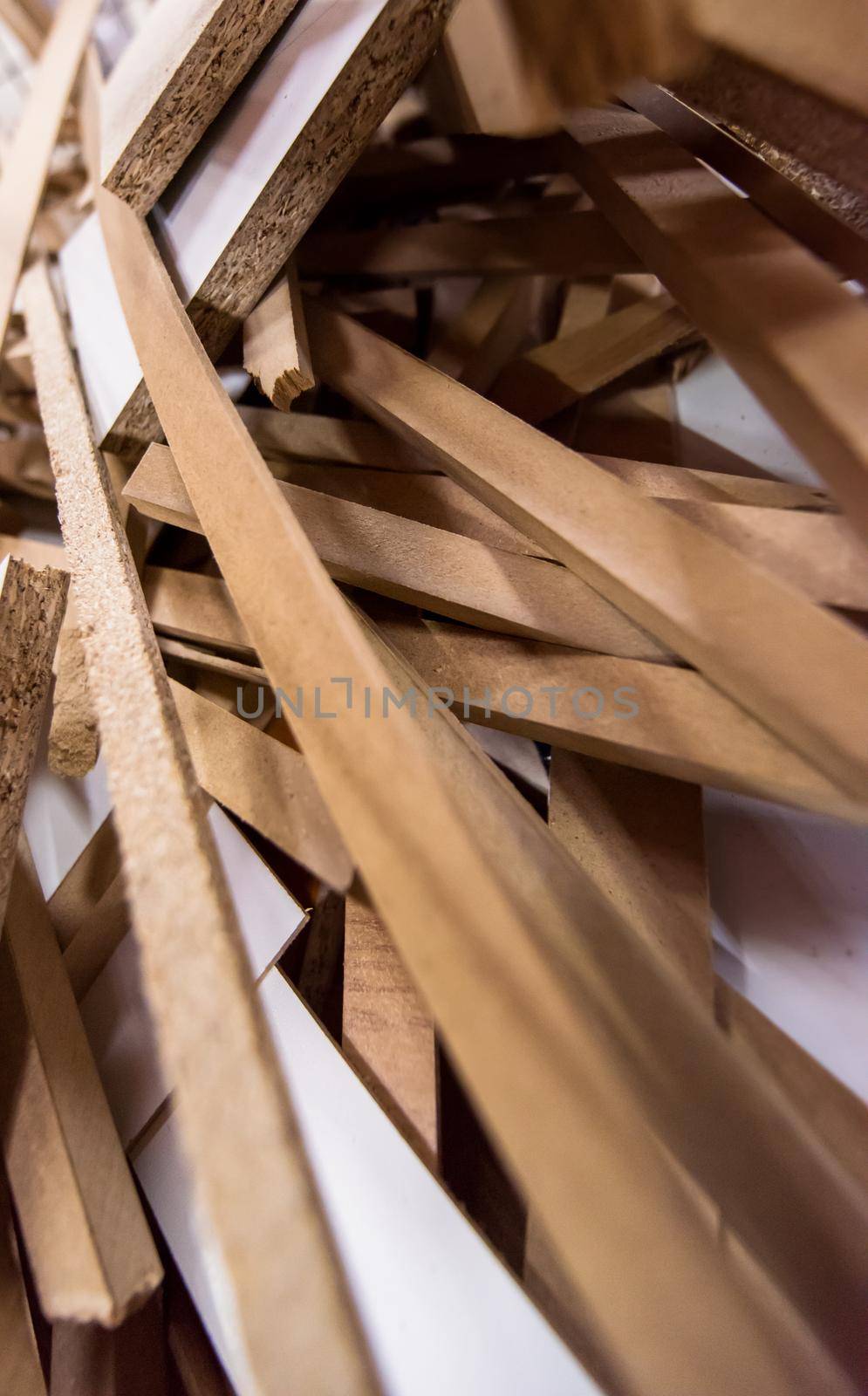Cut wood pieces remaining from carpenter handcraft at manufacturing company, ready to recycle and reuse process