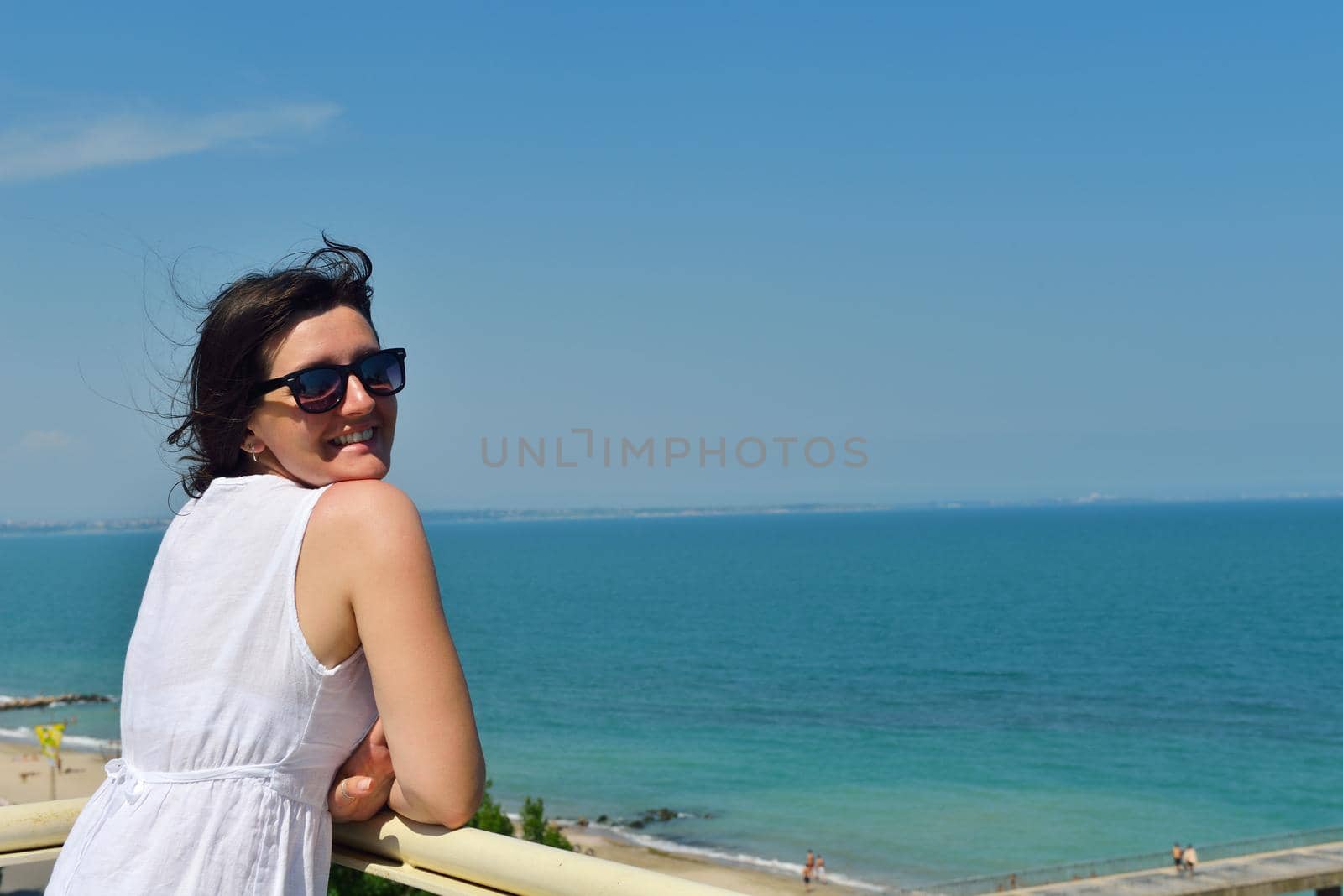 happy young tourist woman have fun while traveling araund city with blue sky and sea in background