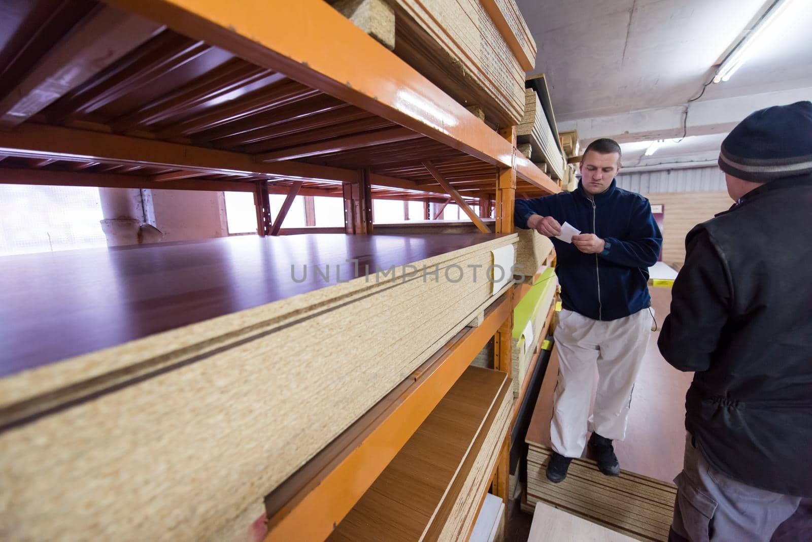 two young carpenters working together in big modern carpentry High quality wood concept