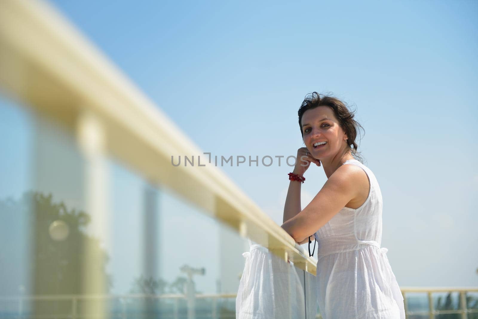 happy young tourist woman have fun while traveling araund city with blue sky and sea in background