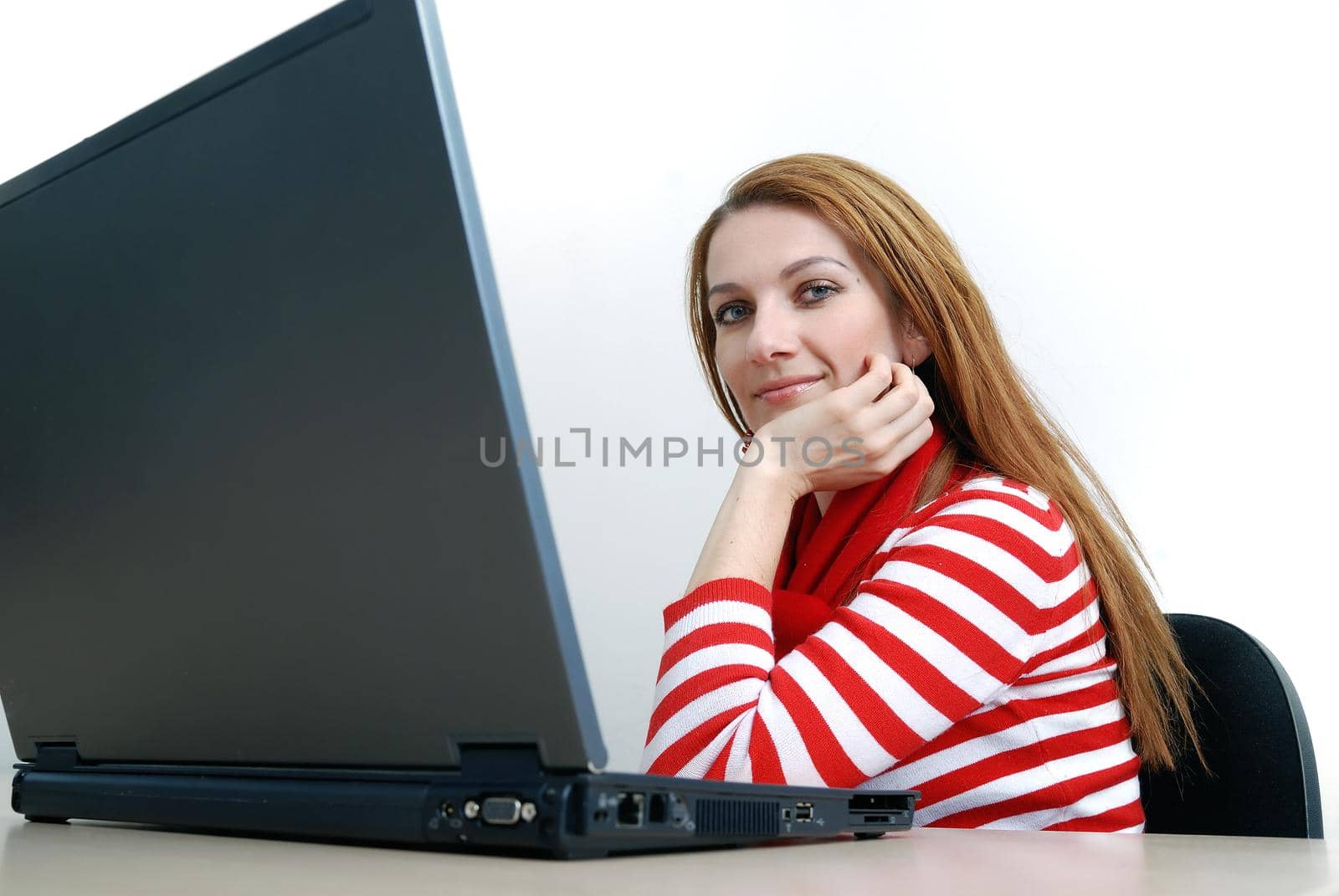 woman in red working on laptop at bright  office