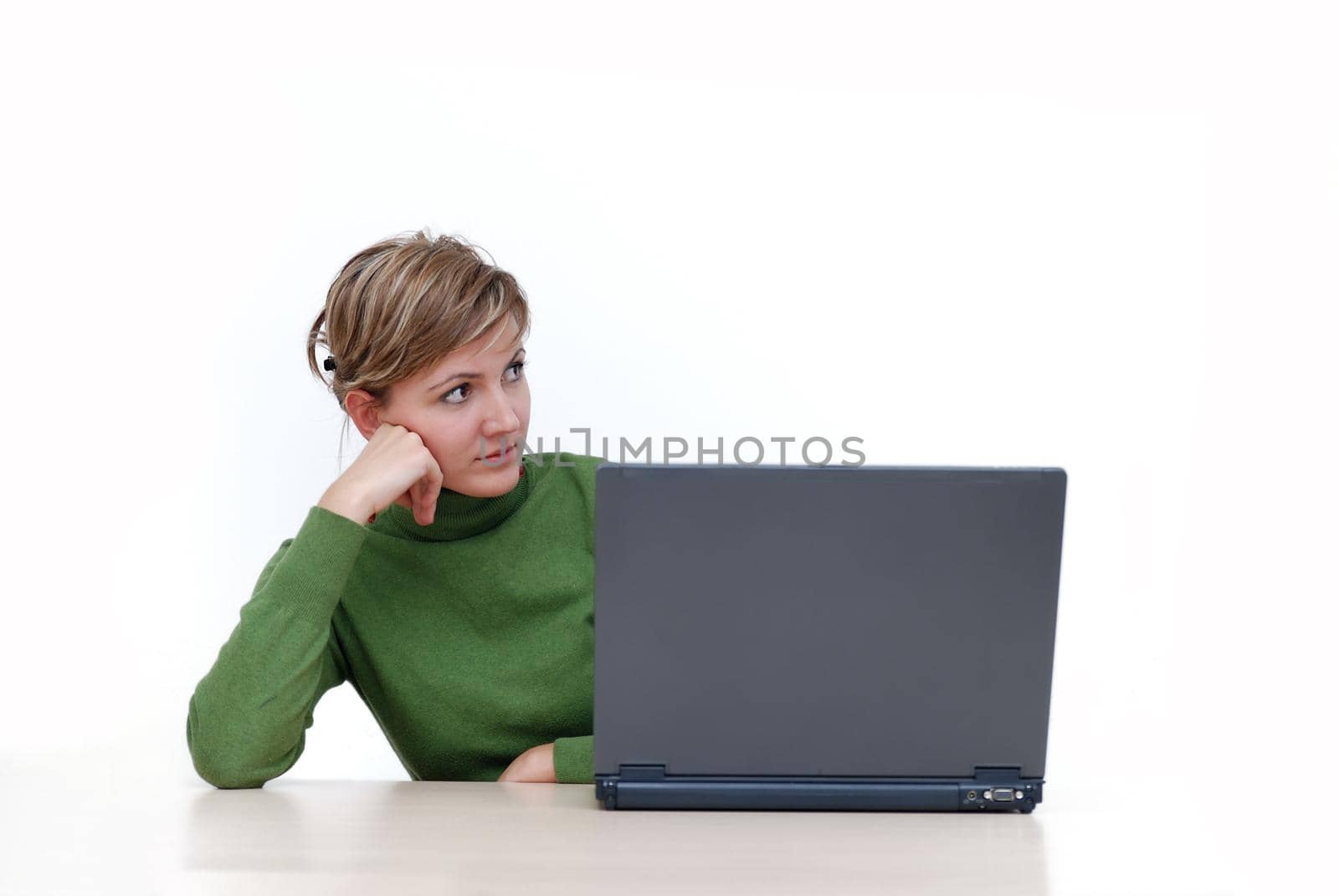 businesswoman in green working on laptop