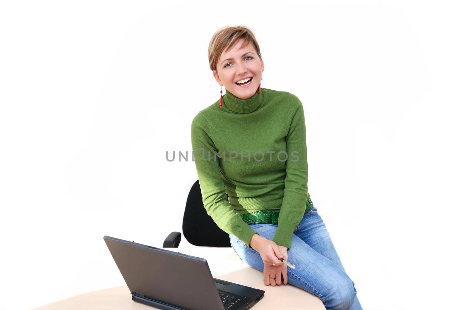 businesswoman in green working on laptop